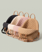 Les quatre coloris du Siège Auto alignés : noir, écru, rose poudré, camel